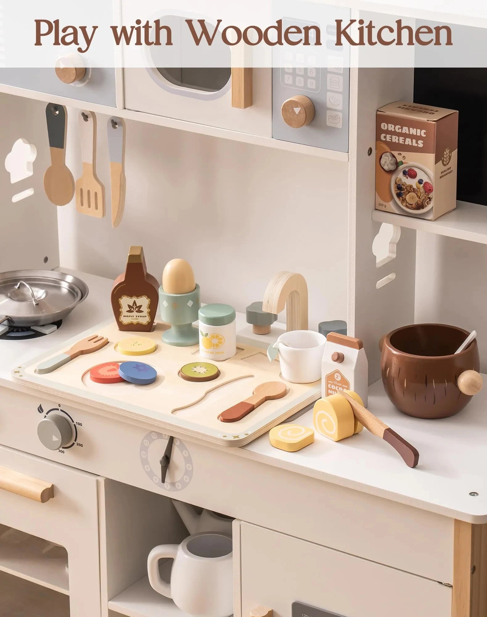 Toy kitchen set with various utensils and items on a white surface.