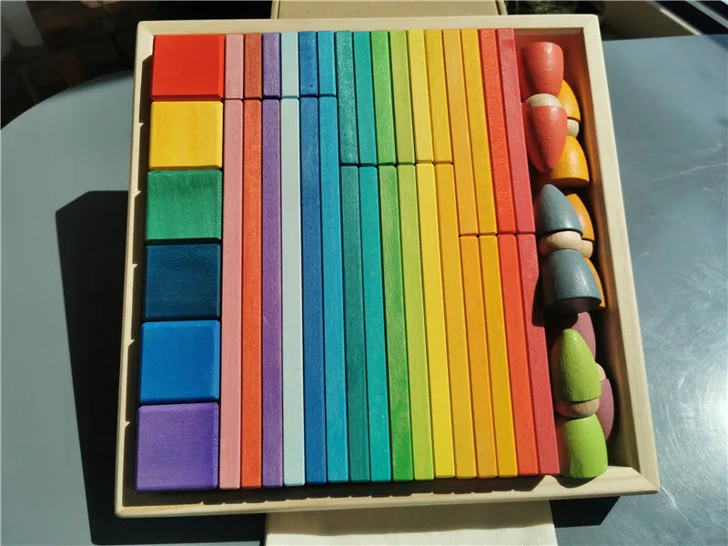 Colorful wooden blocks in a box on a reflective surface