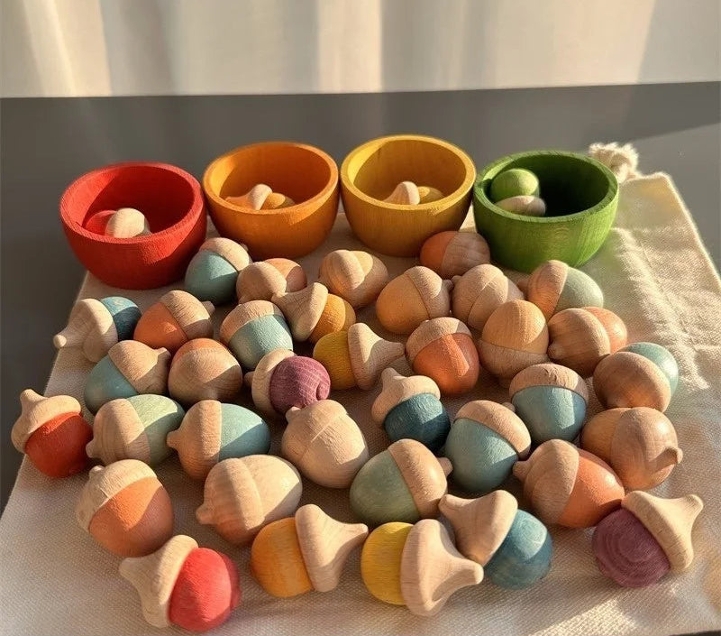 Colorful wooden acorn-shaped toys on a white surface with a neutral background