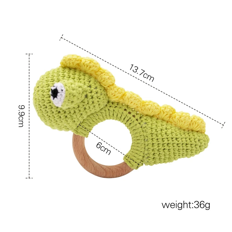 Green crocodile-shaped teething ring with measurements on a white background