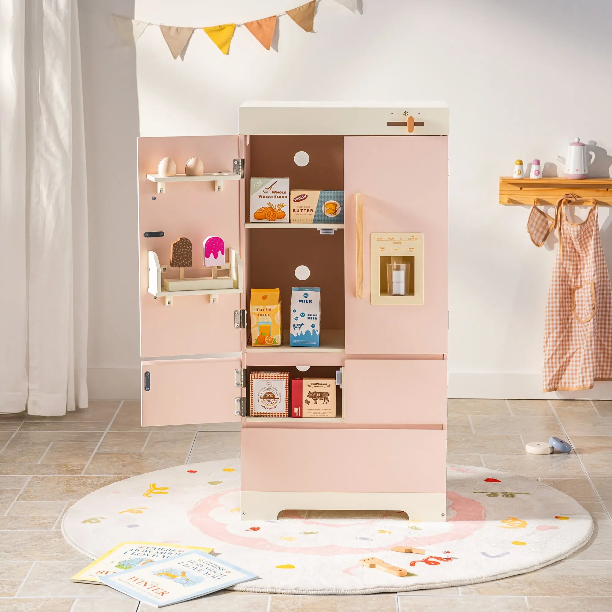 Pink refrigerator with open doors displaying food items in a room with a rug and small table.
