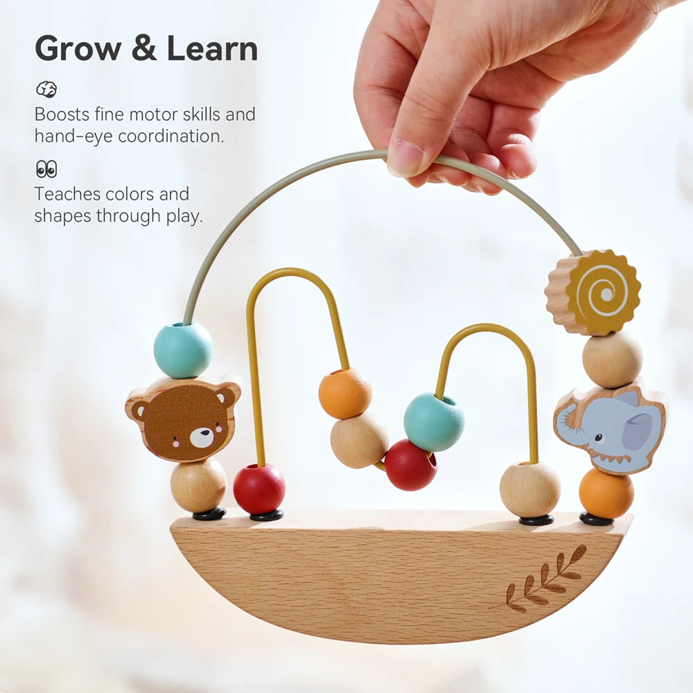 Hand lifting the wooden bead maze by its wire loop