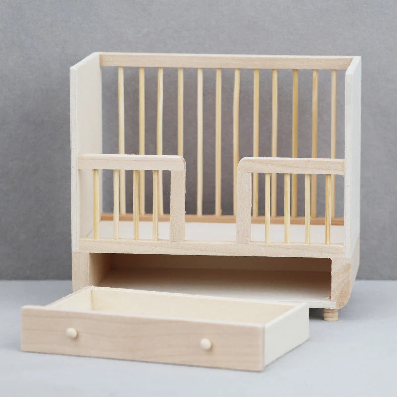 Wooden crib with a drawer on a gray background
