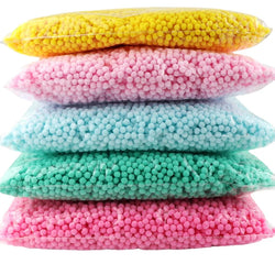 Bulk Mixed Color Craft Pompoms in various sizes, stacked in transparent bags, ideal for enhancing creative projects with vibrant, playful elements.