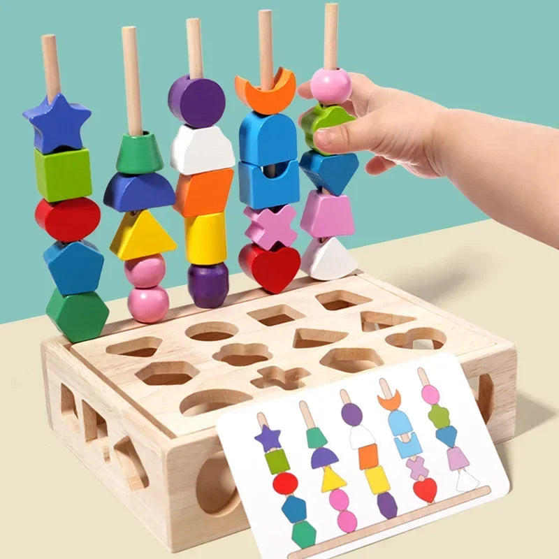 Colorful wooden shape sorting toy with a hand placing a pink object into a wooden box.