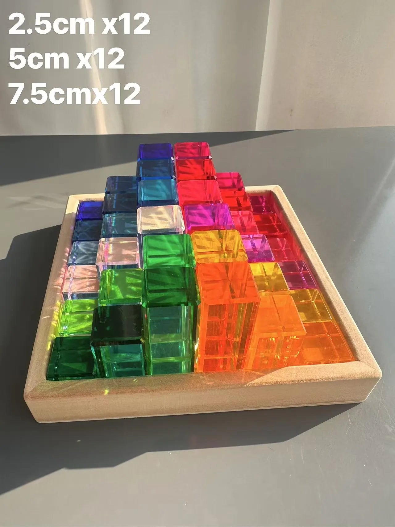 Colorful transparent blocks in a wooden tray with dimensions displayed above.
