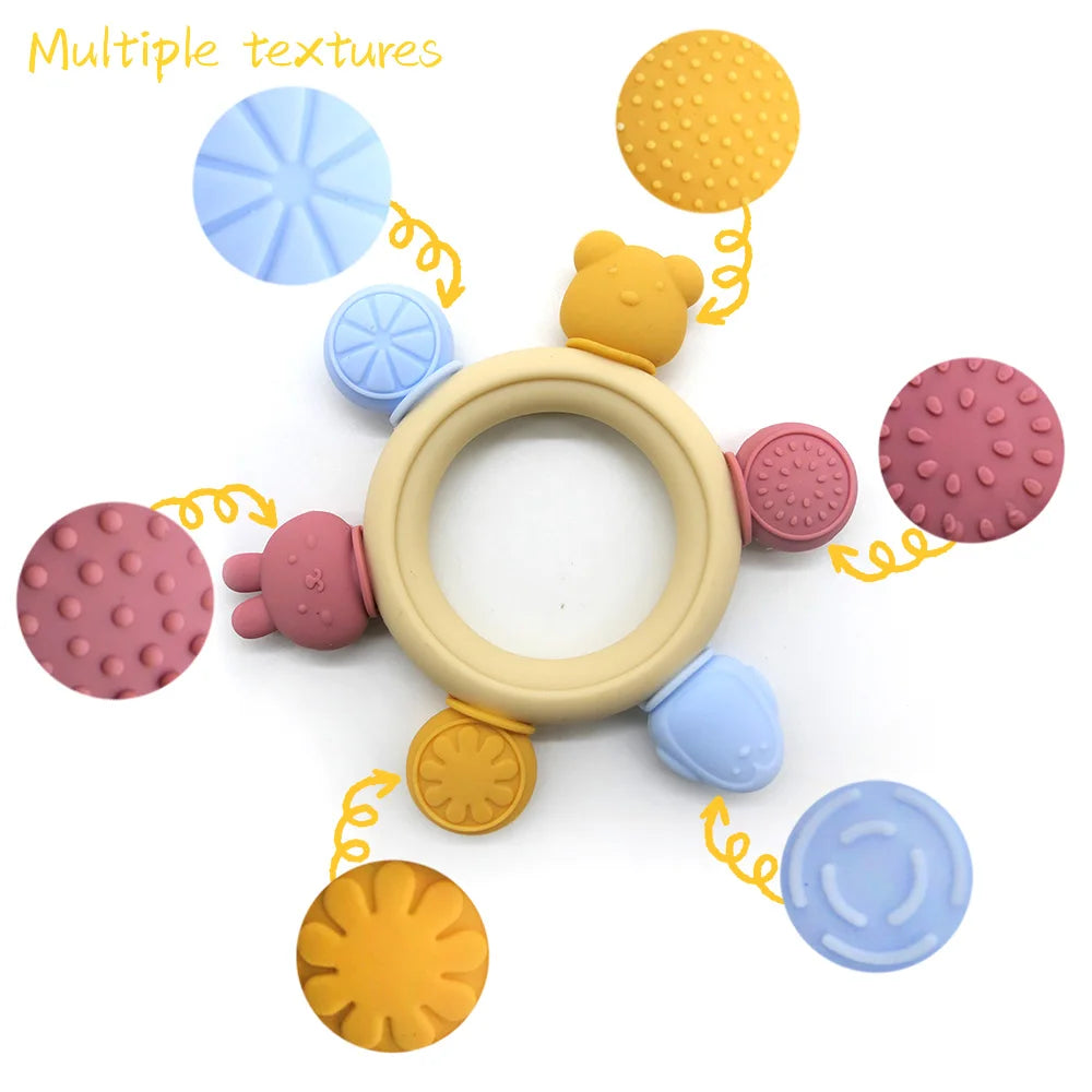 Colorful baby teething ring with multiple textures on a white background