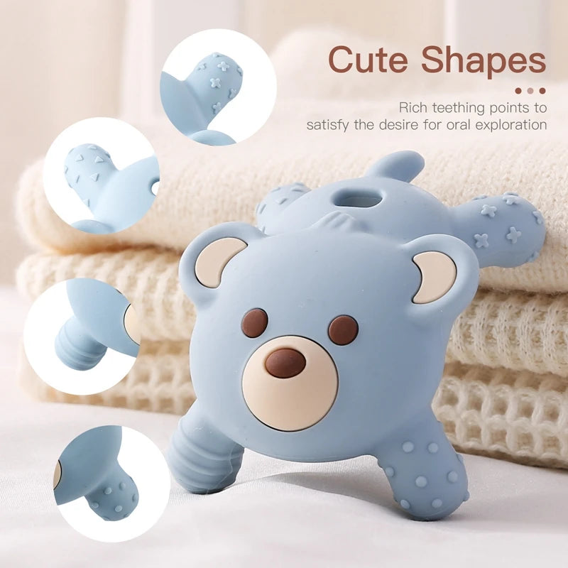 Blue bear-shaped teething toy with text about teething points on a soft background