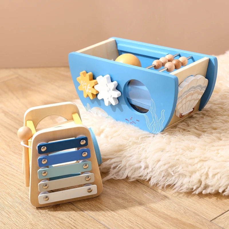 Wooden toy with xylophone and shape sorter on a wooden surface