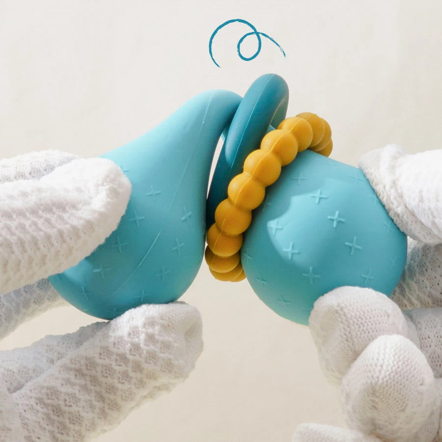 Soft silicone baby teether with rattle rings. Safe, BPA-free & easy to hold. Ideal for teething relief and sensory play. Blue & pink available.

