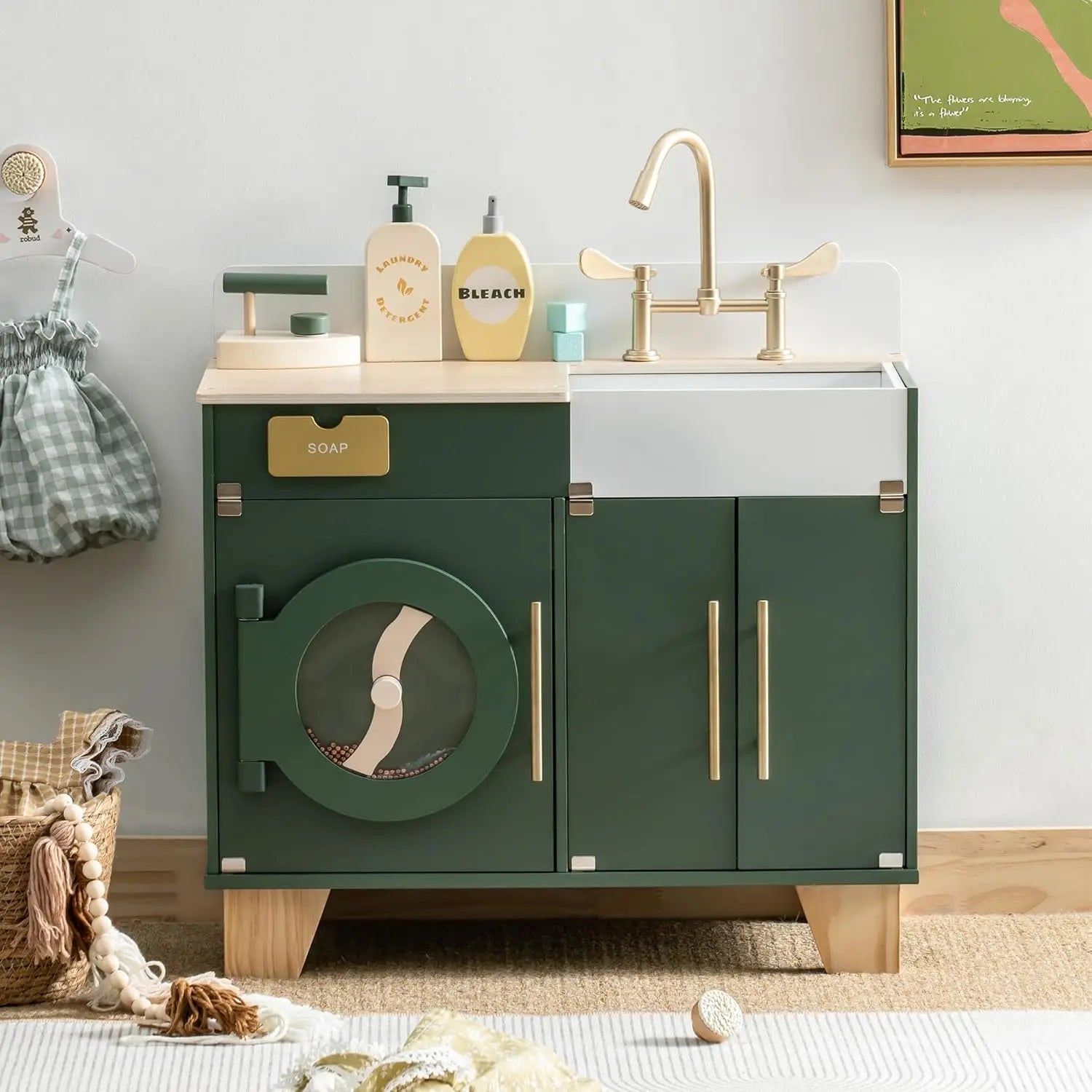 Children's play kitchen set with green cabinet, sink, and toy washing machine.