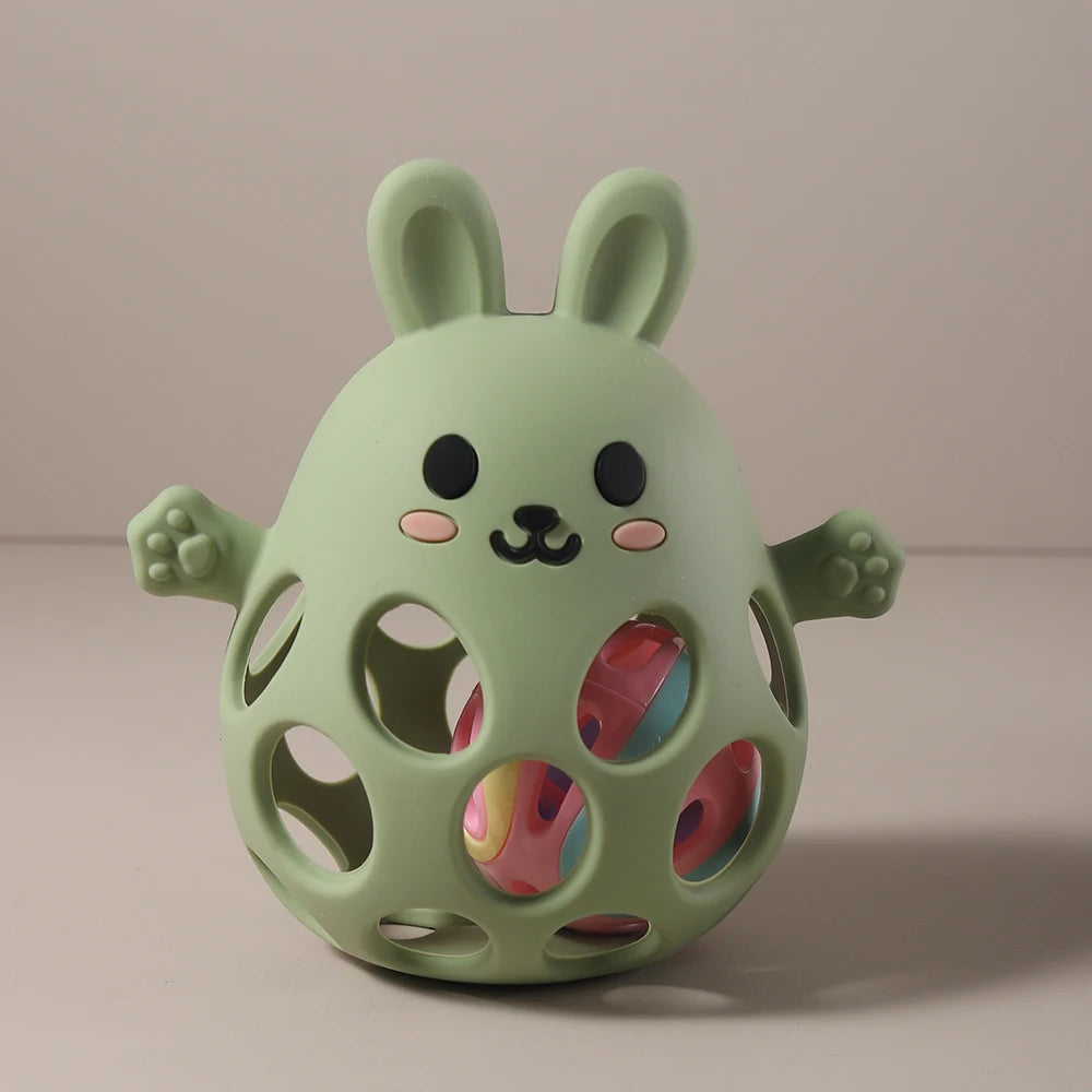 Green rabbit-shaped toy with colorful interior on a beige background