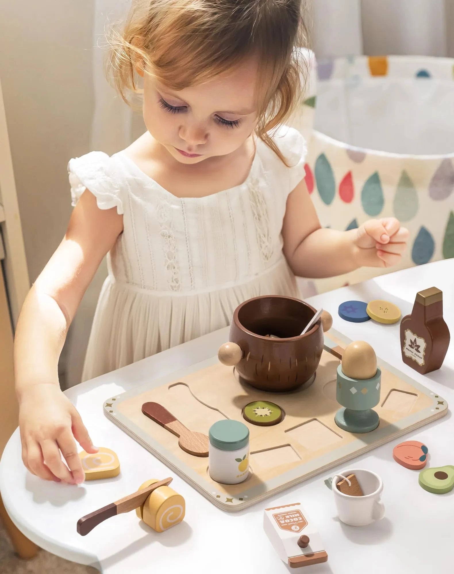 Child playing with wooden toys on a table