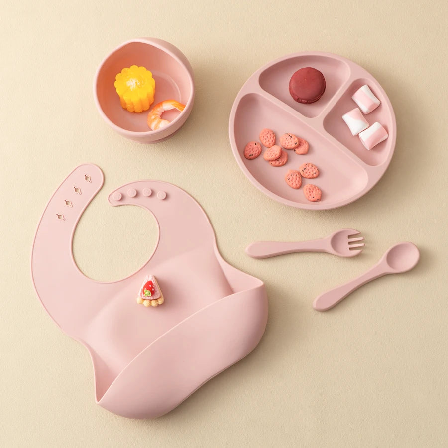 Light pink feeding set with fruit in the plate and bowl