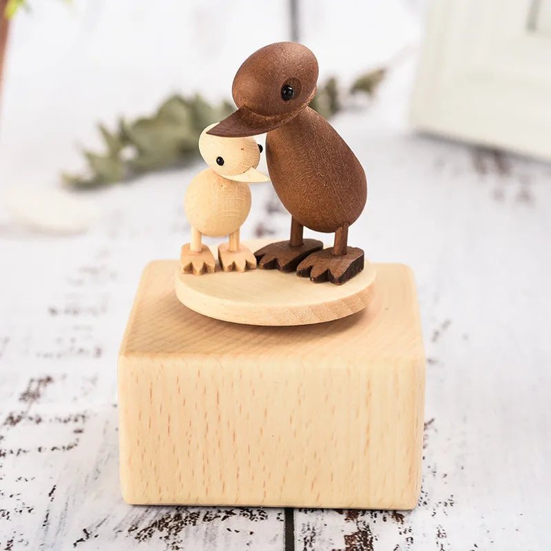 Wooden duck figurines on a wooden base with a blurred natural background | Oliver & Company Montessori toys