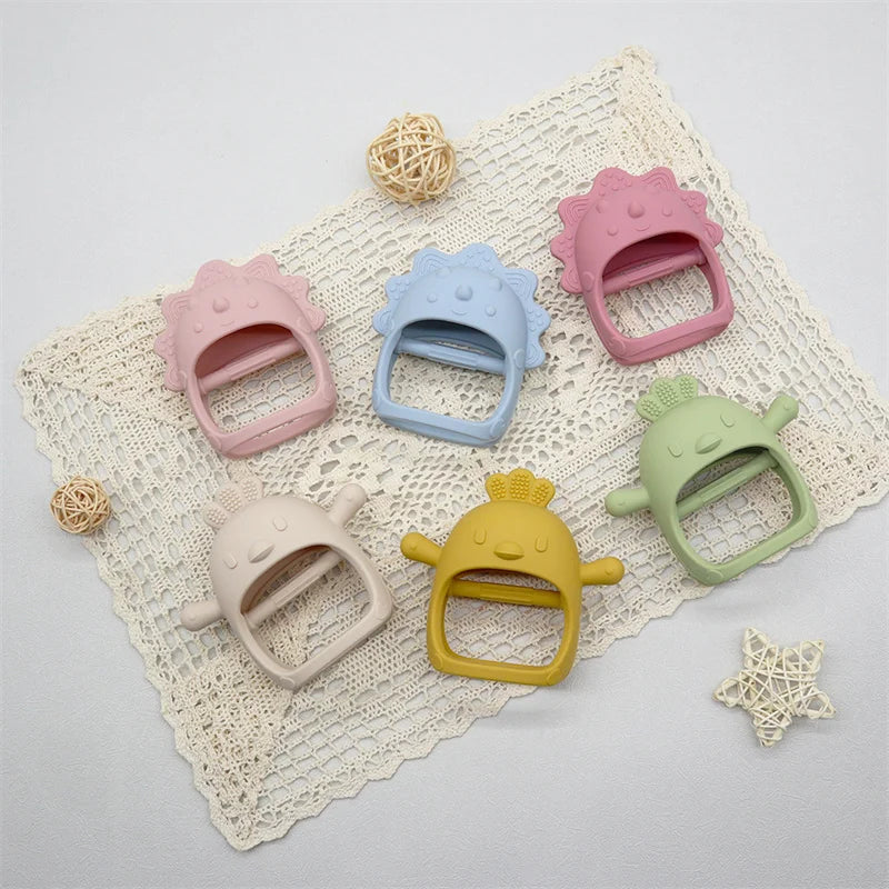 Set of colorful baby teething toys on a textured surface