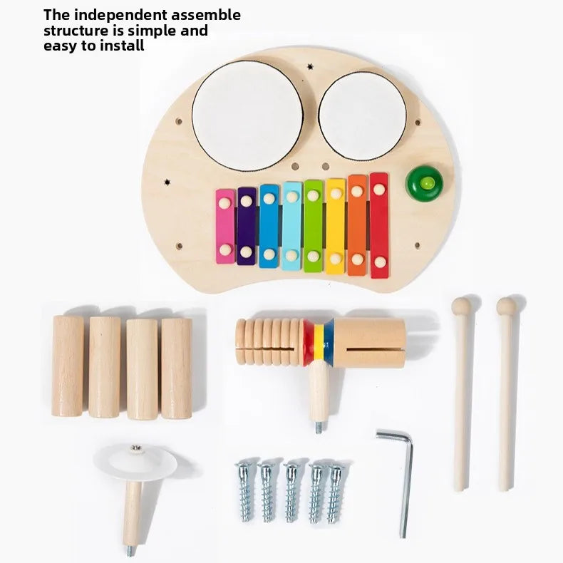 Set of wooden musical instruments with a xylophone, drums, and other tools on a white background.