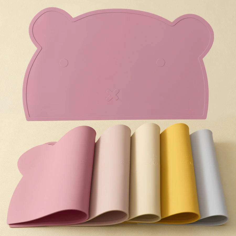 Powder rose bear placemat with rolled placemats in other colors