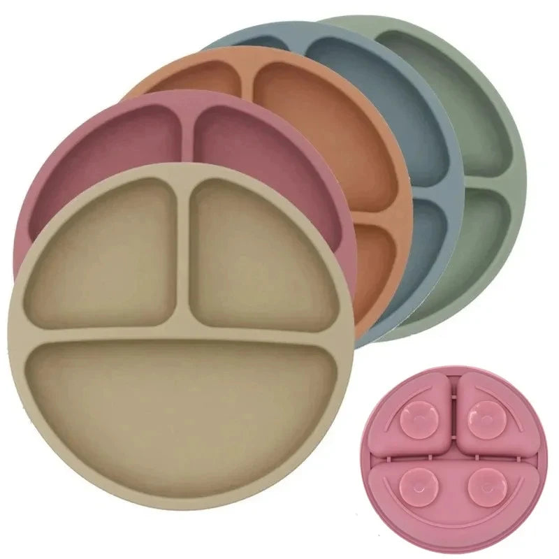Set of colorful silicone divided plates on a white background