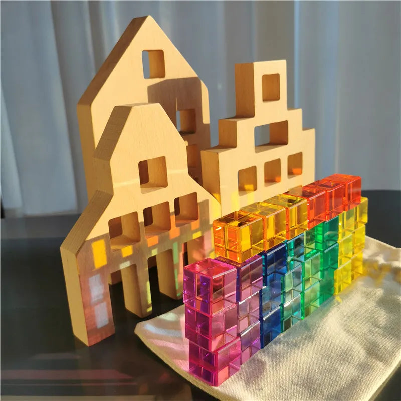 Wooden and transparent colorful building blocks on a reflective surface with a neutral background