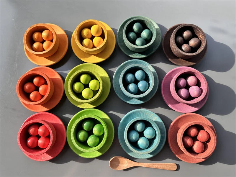 Colorful bowls with spherical objects on a gray background
