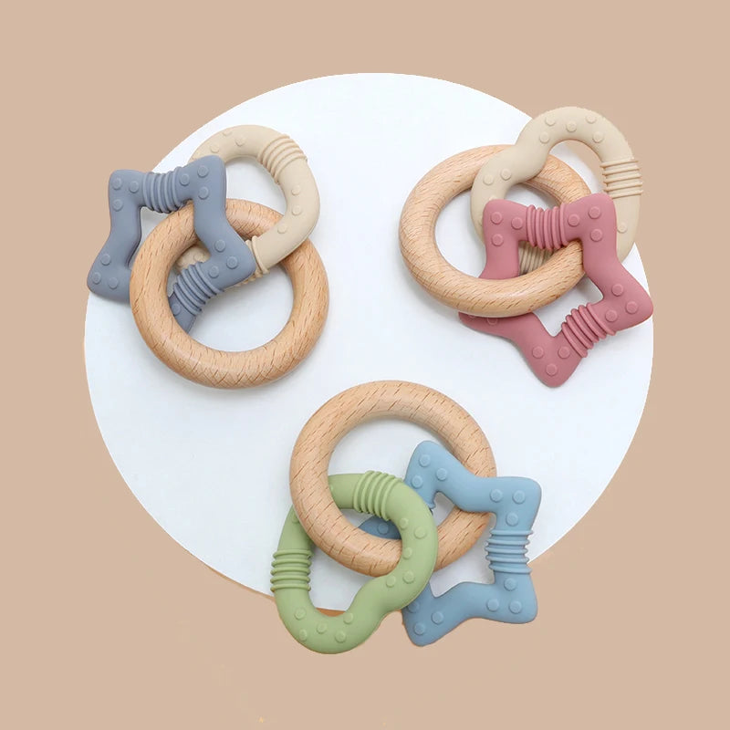 Set of colorful baby teething rings on a beige background