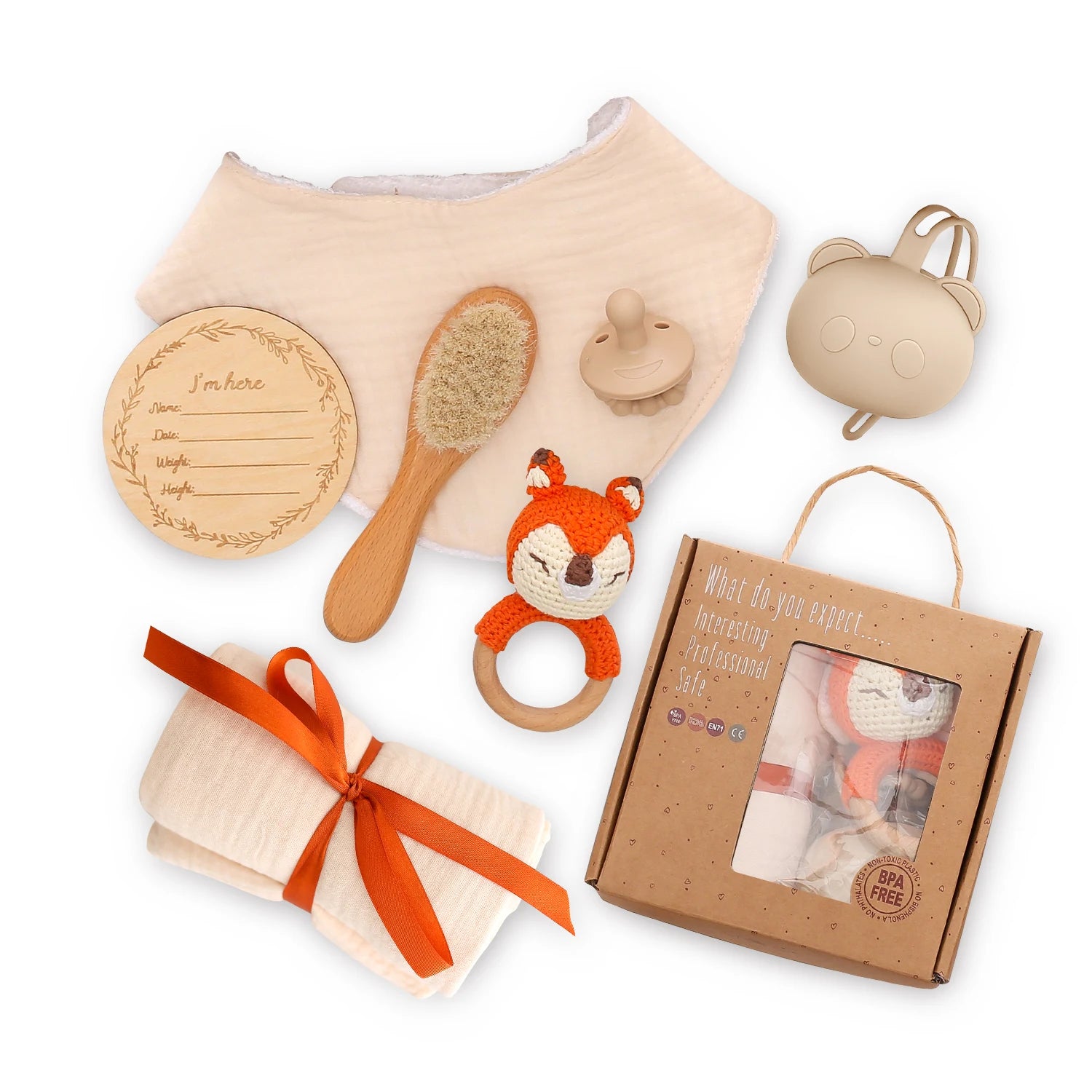Collection of baby items including a hairbrush, rattle, and gift box on a white background