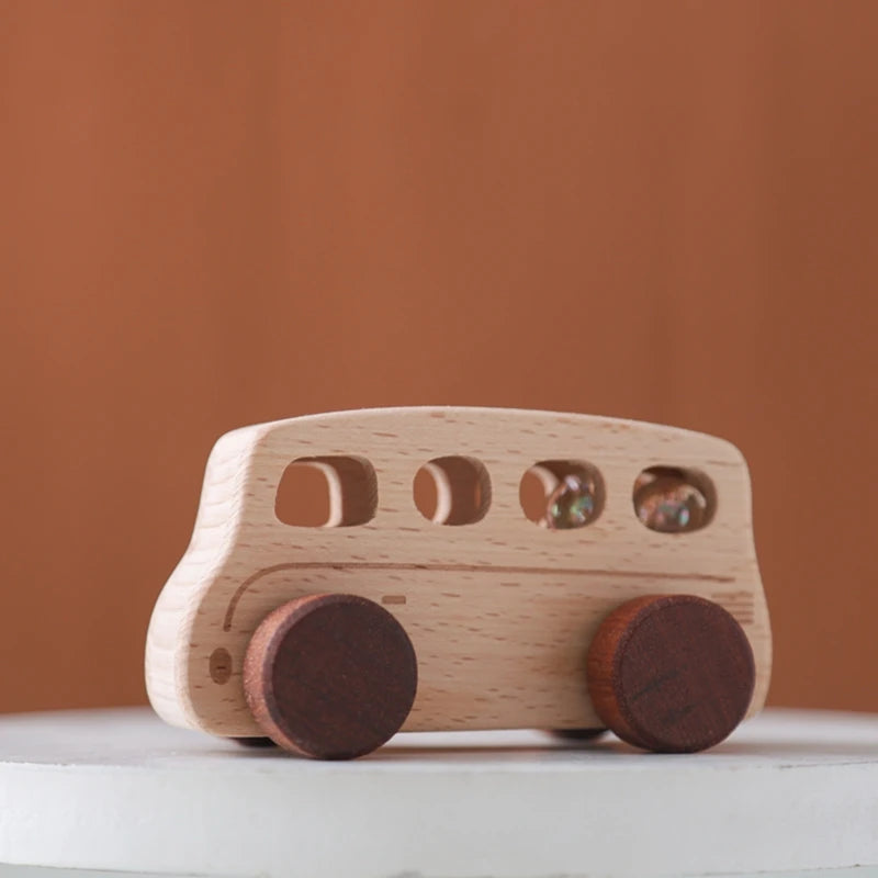 Baby Montessori Wooden Cartoon Bus, a beech wood toy with round wheels, promoting imaginative play and motor skill development for young children.