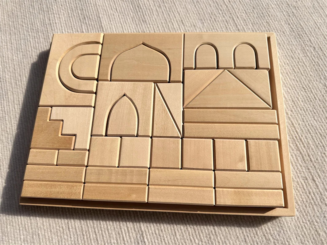 Set of wooden architectural models on a textured surface