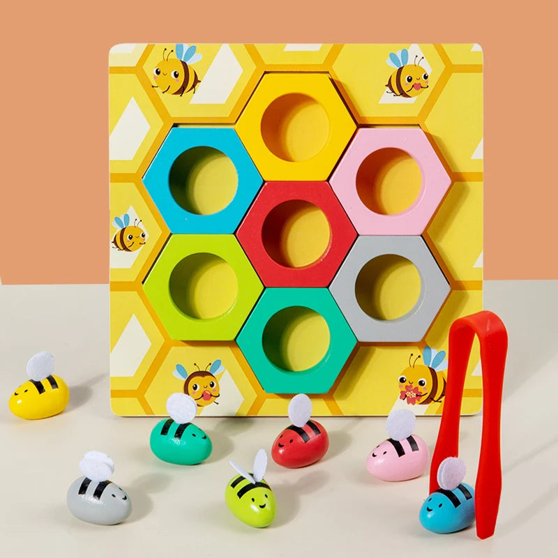 Colorful geometric shape sorting toy with bee characters on a hexagonal patterned board.