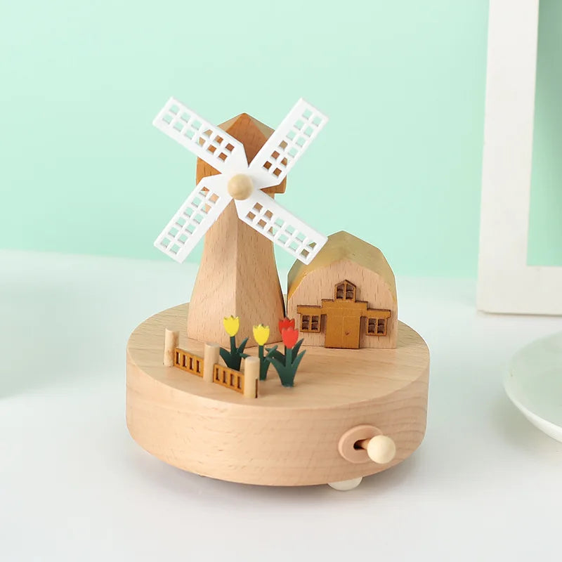 Wooden windmill toy with a house and flowers on a light green background