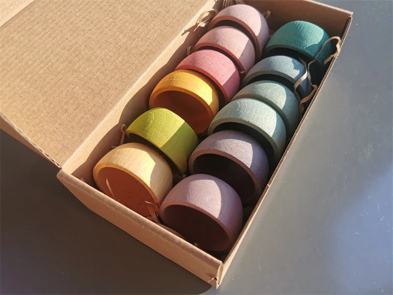 Box of colorful ceramic cups on a gray surface