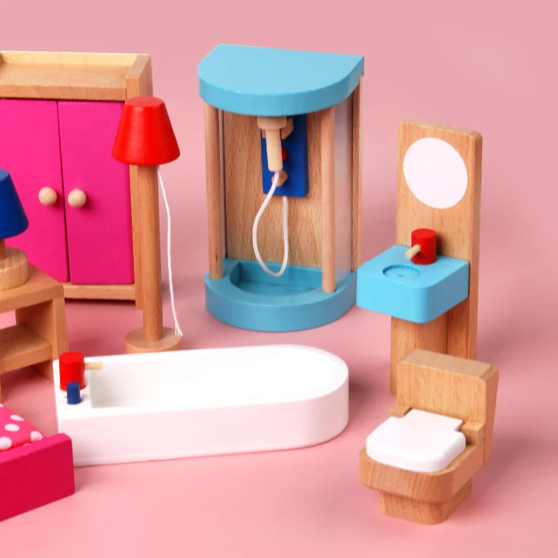 Colorful toy bathroom set with sink, toilet, and mirror on a pink background