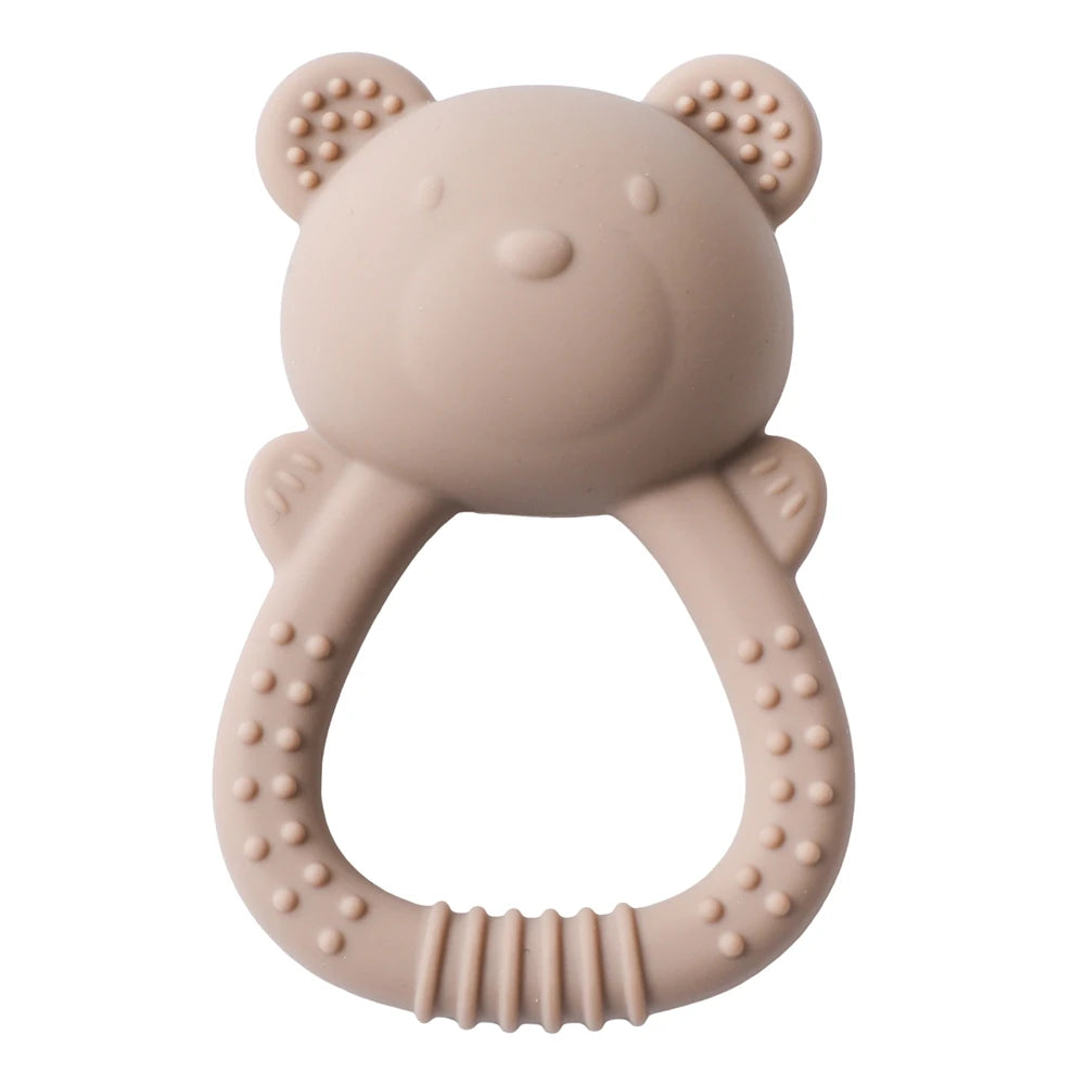 Pink bear-shaped teething ring on a white background