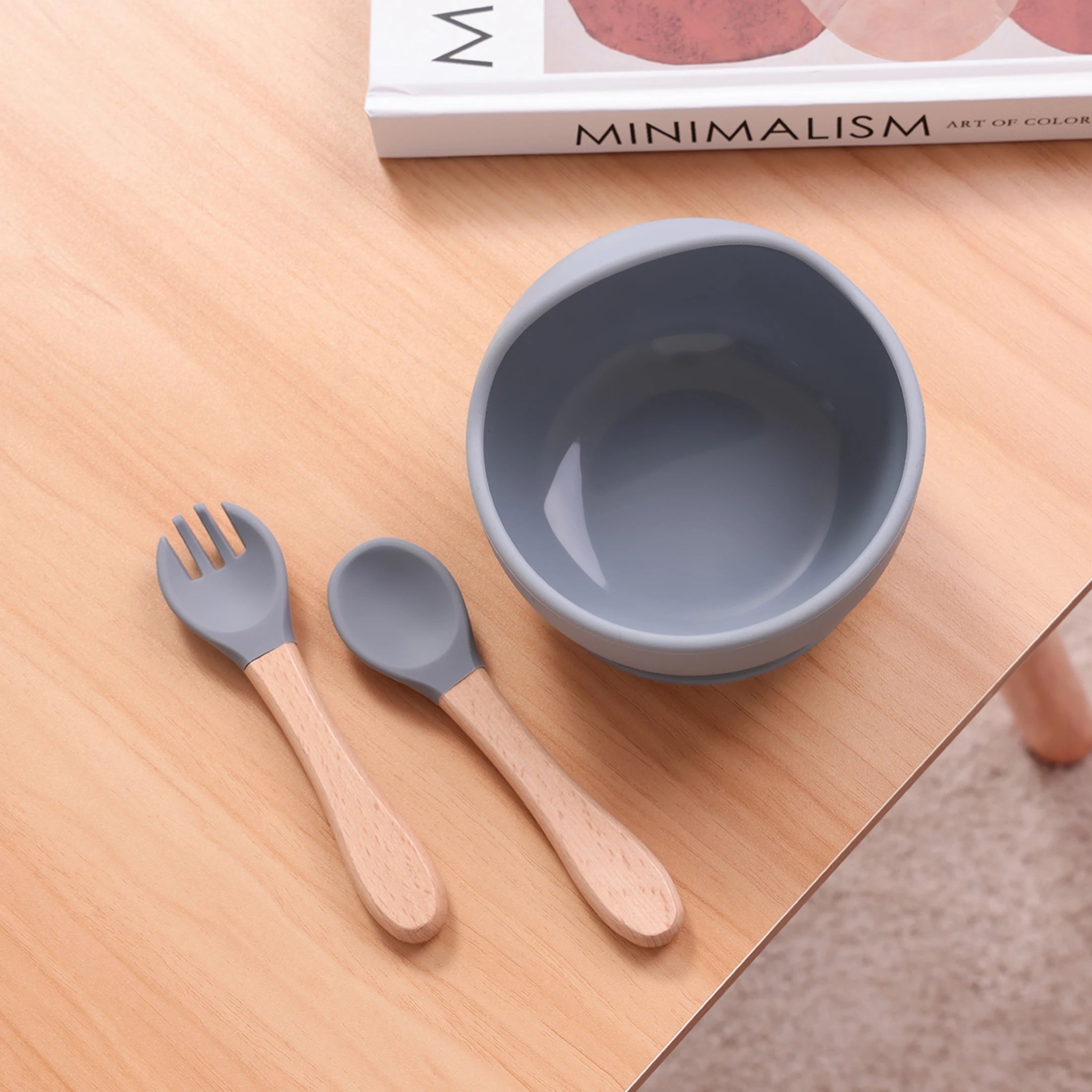 Grey blue suction bowl with wooden spoon and fork