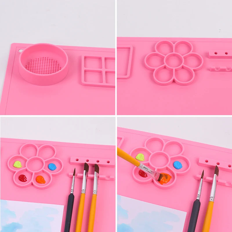 Pink art mat with various compartments for painting tools and materials on a white background.