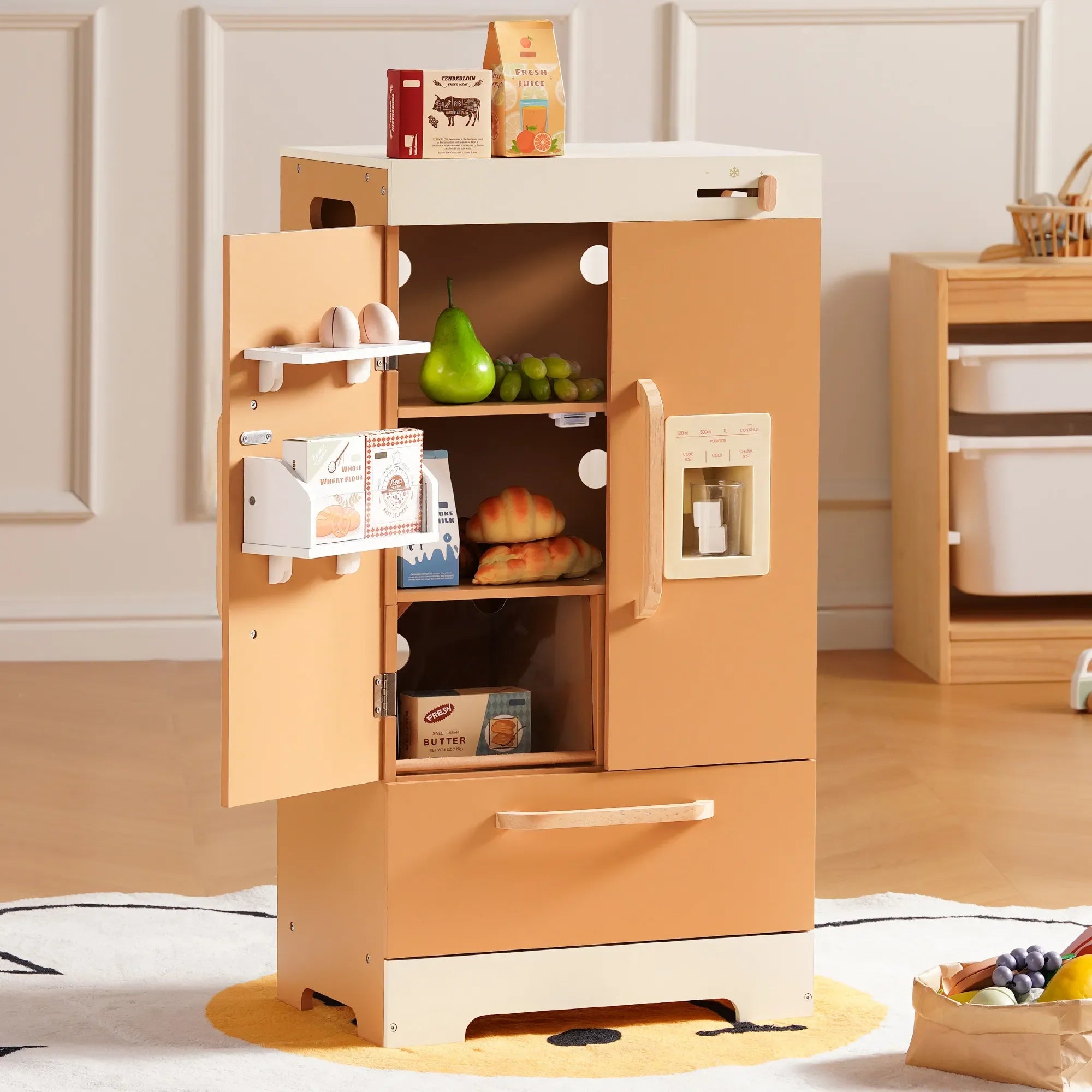 Wooden toy kitchen with open doors showing food toys inside, on a light wooden floor.