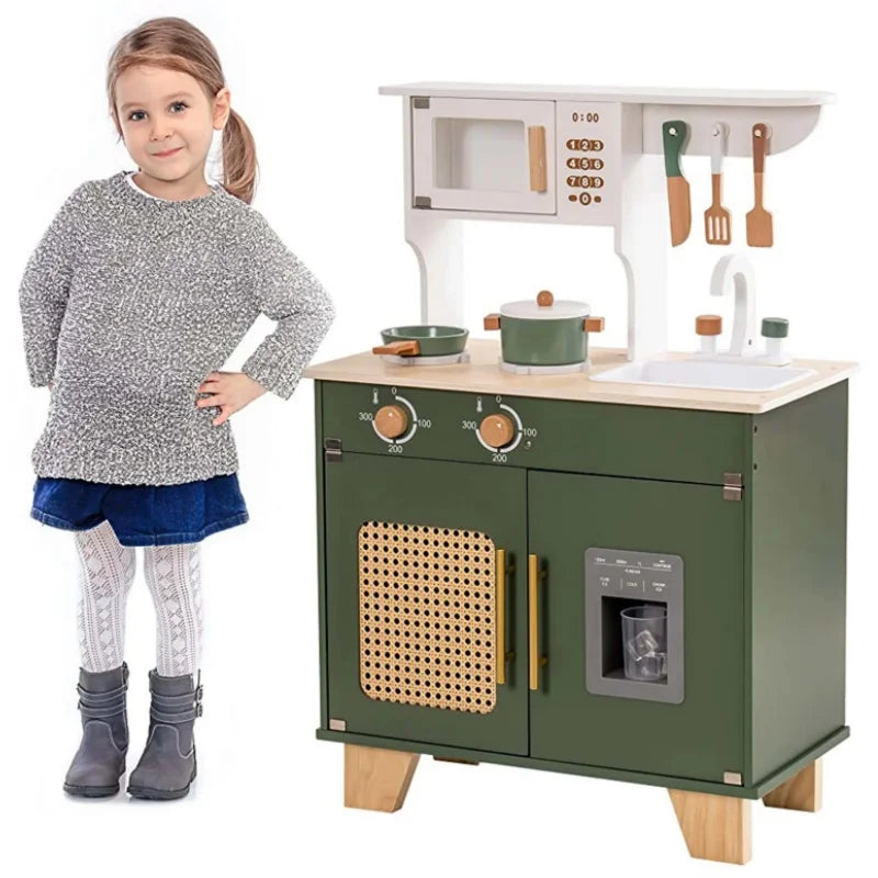 Child standing next to a toy kitchen set on a white background