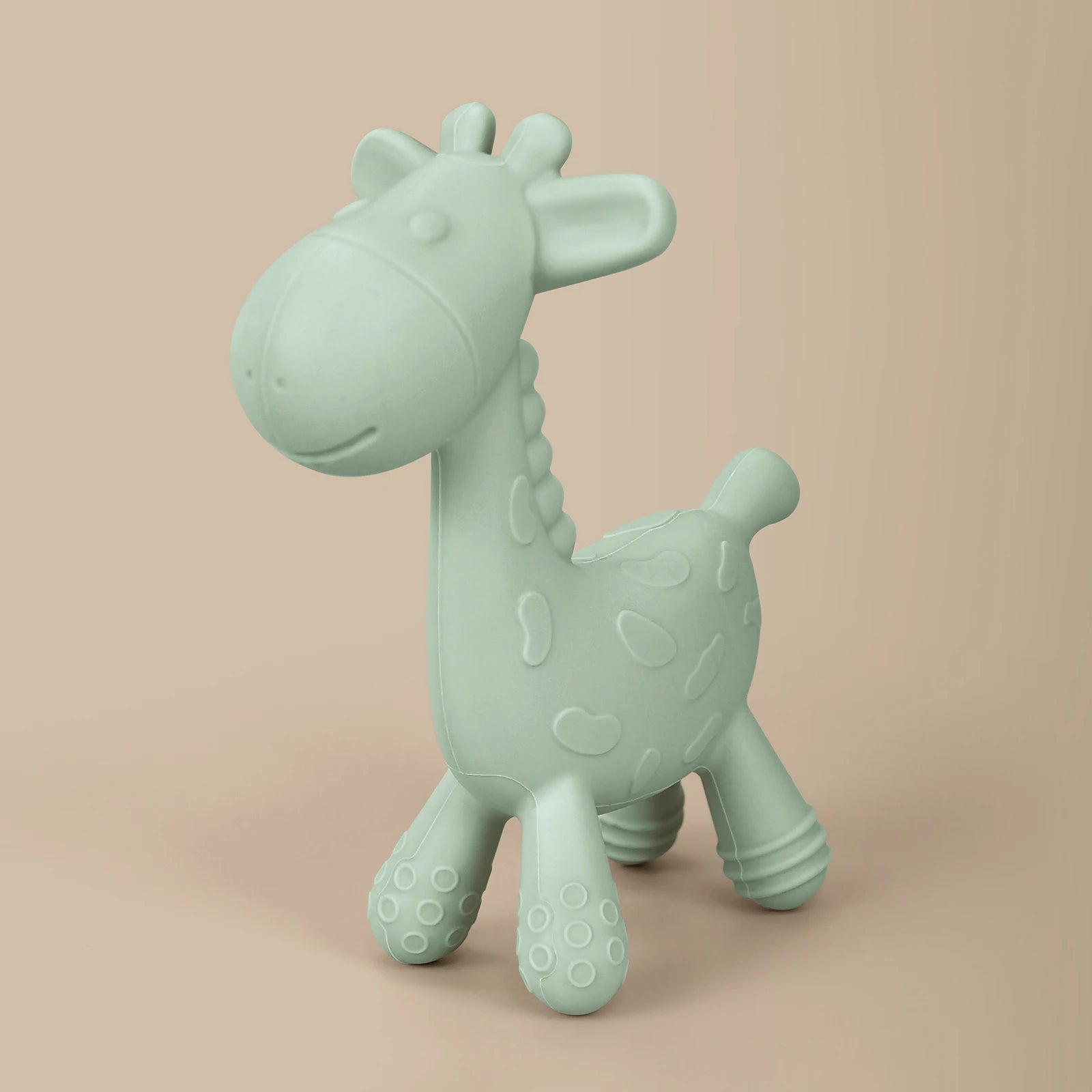 Mint green giraffe-shaped toy on a beige background