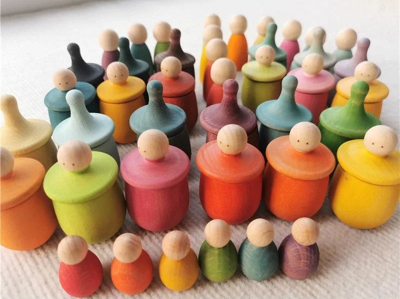 Colorful wooden peg dolls arranged on a textured surface