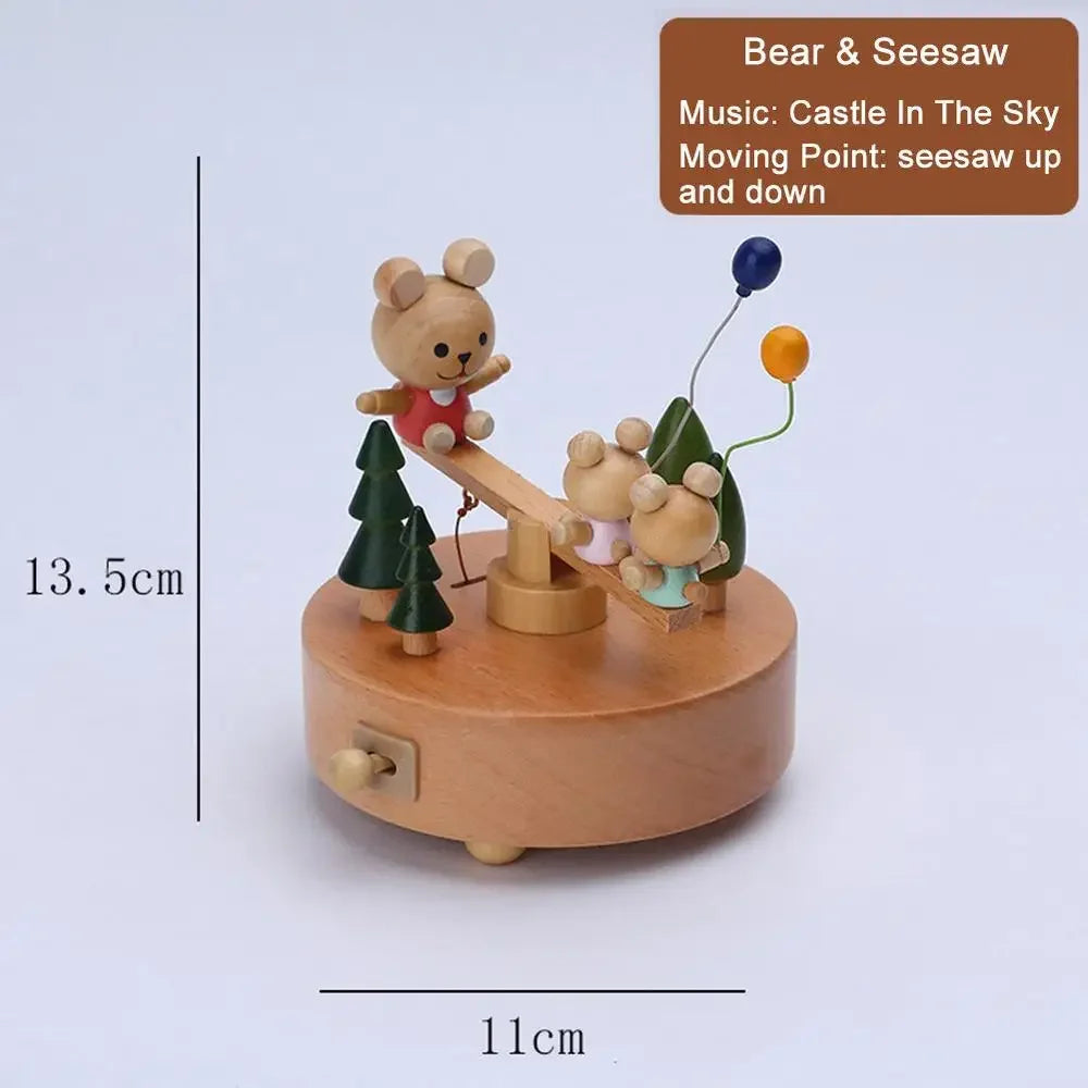 Wooden music box with bear and seesaw design, featuring a measurement label on a light blue background  | Oliver & Company Montessori Toys