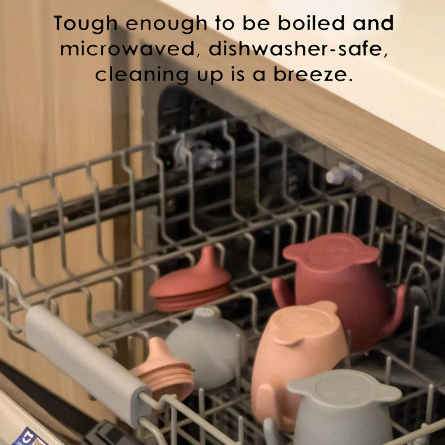 Dishwasher with ceramic pots and pans inside, text about durability and ease of cleaning.