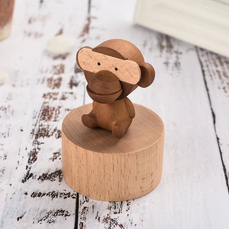 Wooden monkey figurine on a round wooden base on a rustic wooden  | Oliver & Company Montessori toyssurface