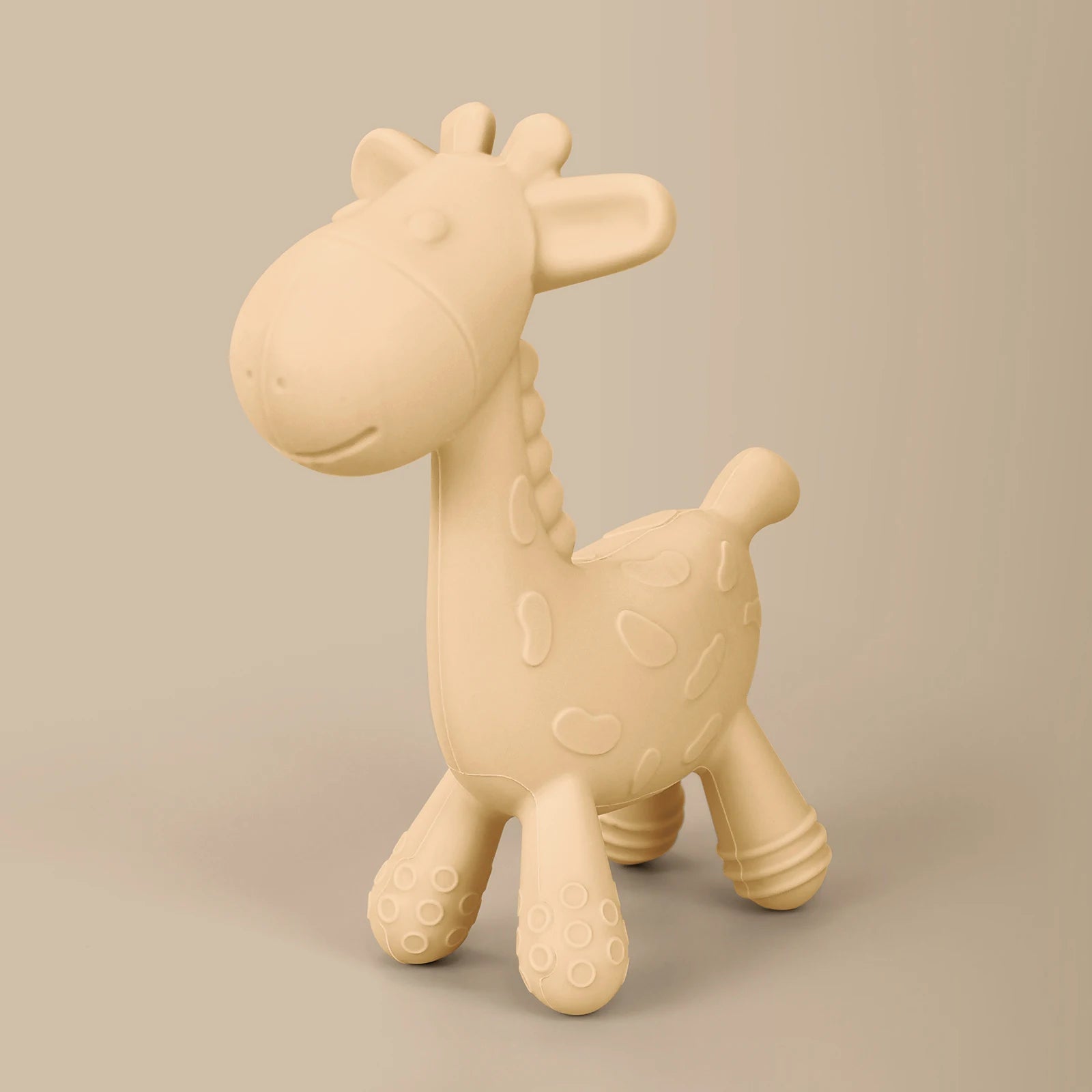 Beige giraffe-shaped toy on a beige background