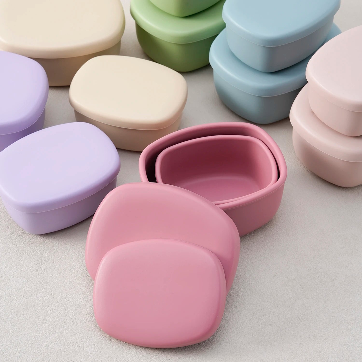 Rose silicone containers nested together with lids off