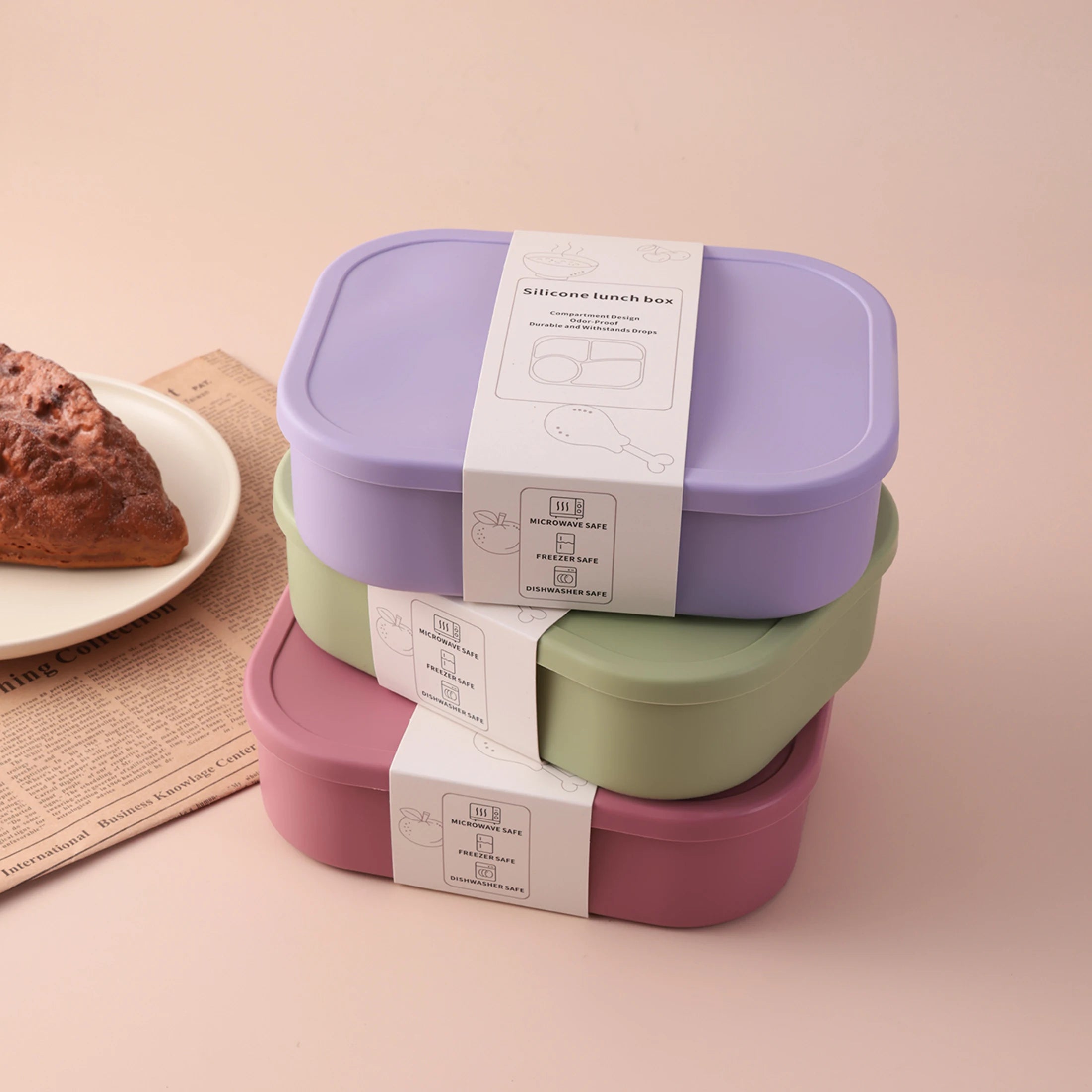 Stacked 4-compartment bento boxes in lavender, sage and rose