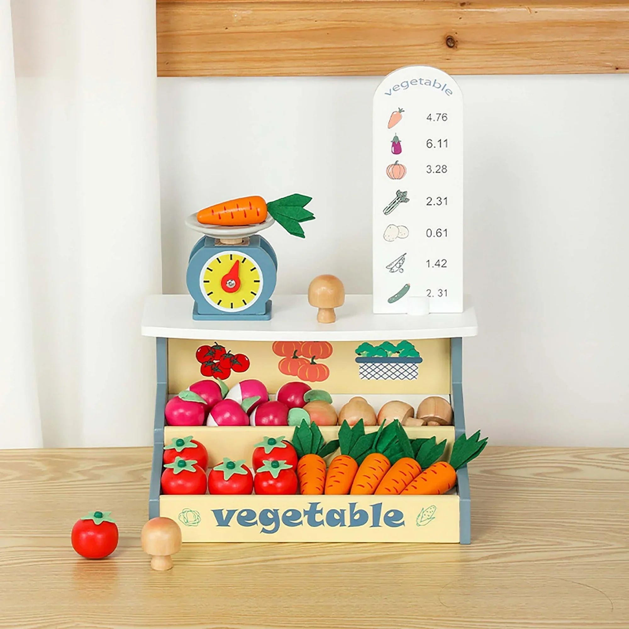 Toy vegetable set with a scale, vegetables, and a chart on a wooden shelf.
