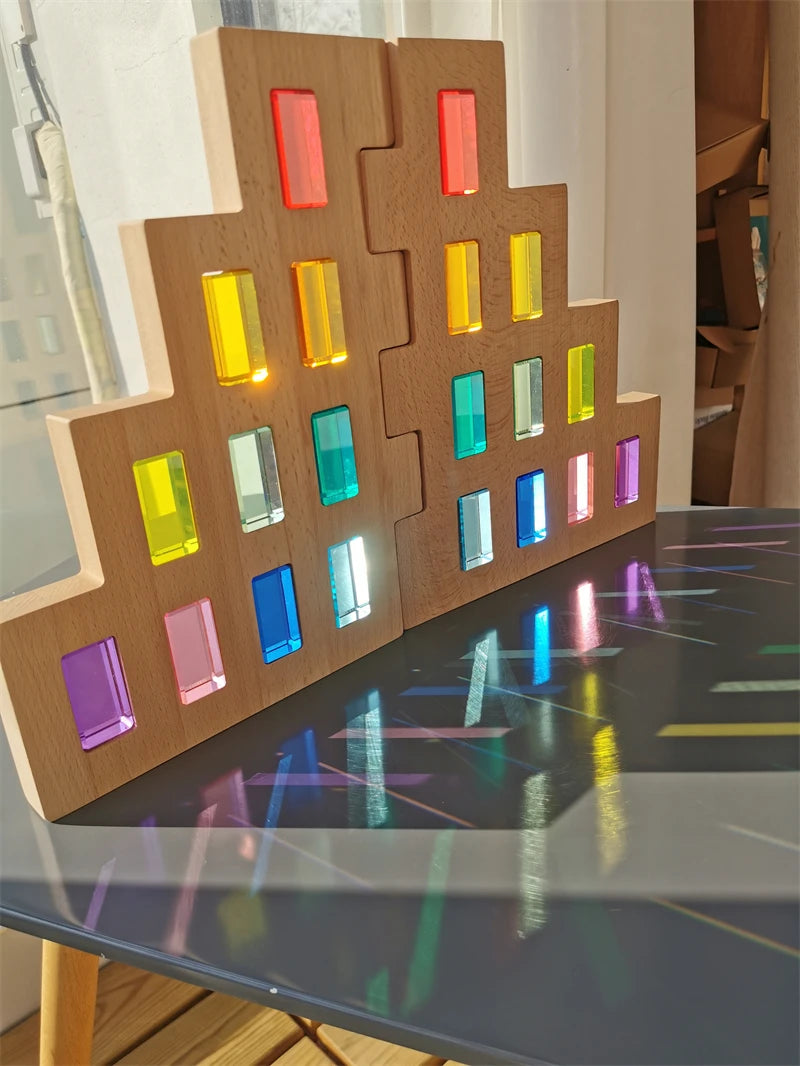 Wooden block puzzle with colorful transparent blocks on a reflective surface.