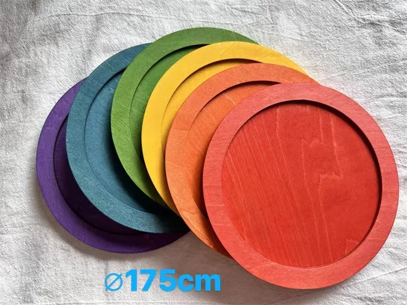 Set of rainbow-colored plates on a textured surface with a measurement label.