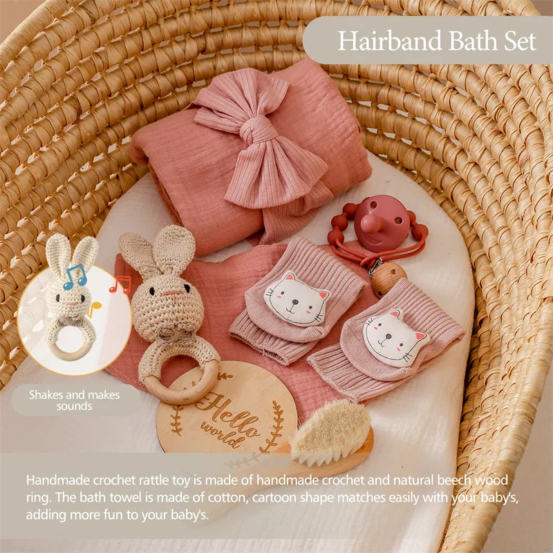 Baby bath set with towel, rattle, and toys in a wicker basket